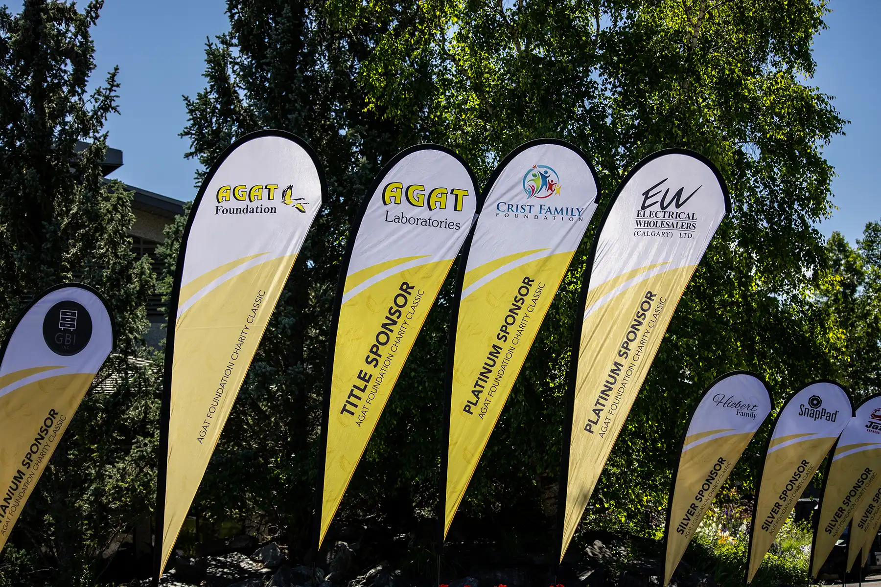 Sponsor flags at the AGAT Foundation Charity Classic golf tournament in Kananaskis, Alberta.