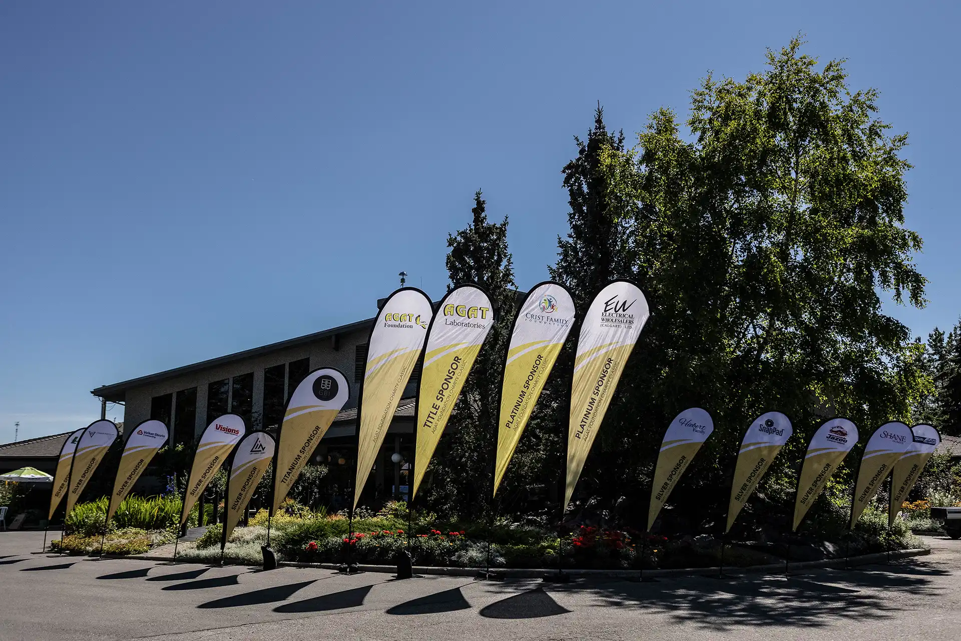 Blue Prostate Cancer Centre tent and banner with volunteers running a 50/50 raffle on the golf course at Priddis Greens during the AGAT Priddis Greens Charity Classic.